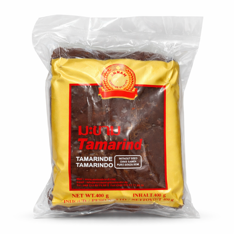 Packaged tamarind product with a yellow label and red text on a white background