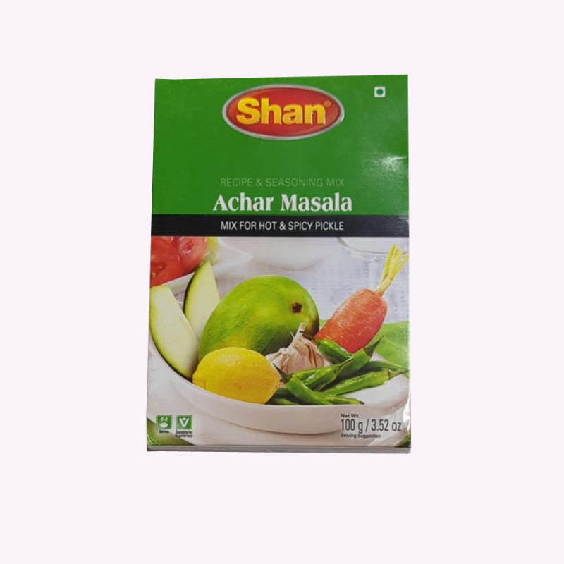 Shan Achar masala green pack with vegetables on it against white background