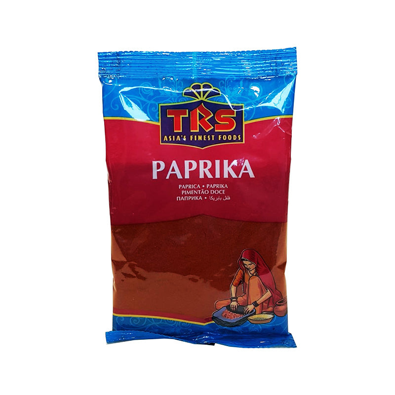 Packaging of TRS Paprika 100g showing the product name and a picture of a person holding a container of paprika.