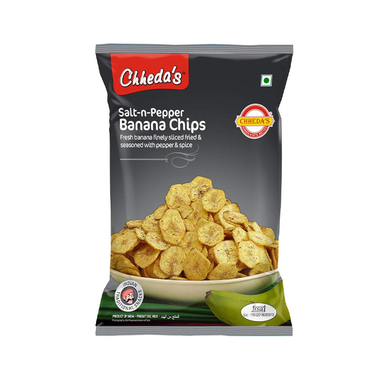 A package of Chheda's Salt-n-Pepper Banana Chips featuring an image of the chips and sliced bananas, with branding and product information.