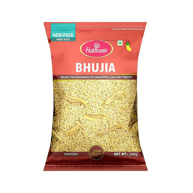 A package of Haldiram's Bhujia, which are puffed rice snacks, in a red and clear packaging showing the product clearly.