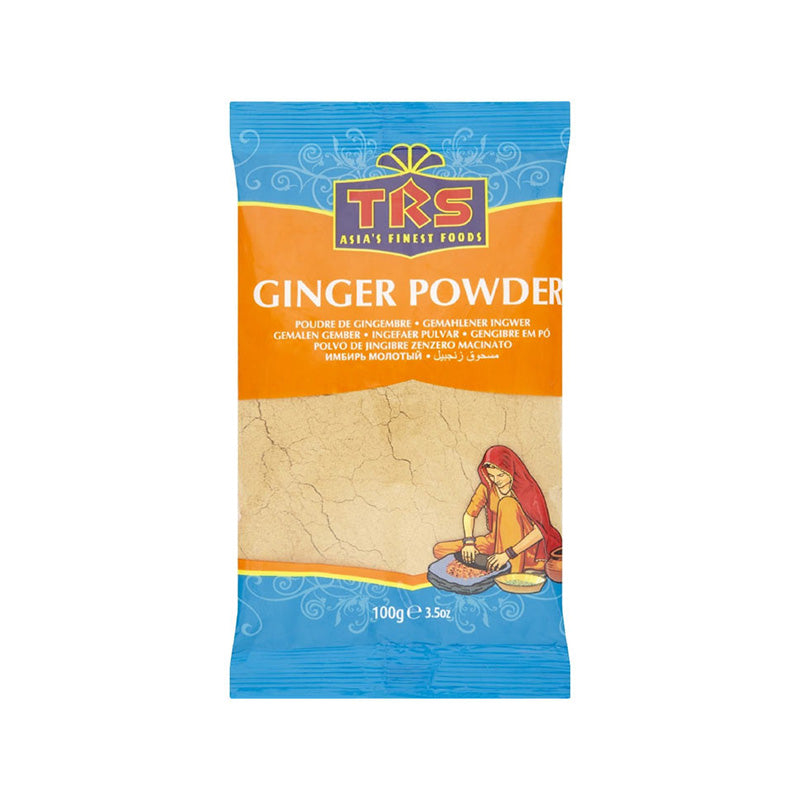 A package of TRS Ginger Powder, showing the product name and an illustration of a woman grinding ginger. The pack is predominantly orange and blue with a clear window showing the ginger powder inside.